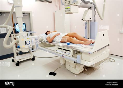 Woman Having Barium Enema On Table Of Siemens Medical Solutions Axiom Iconos R200 Fluoroscopy