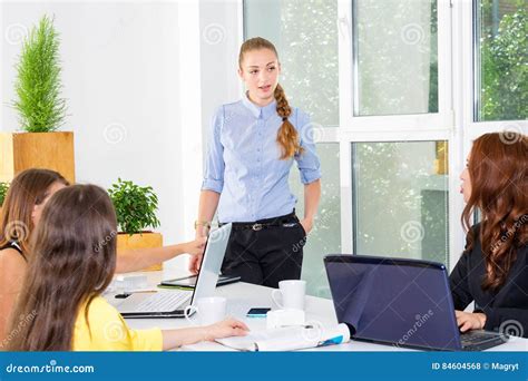 Pretty Young Business Woman Giving A Presentation In Conference Or