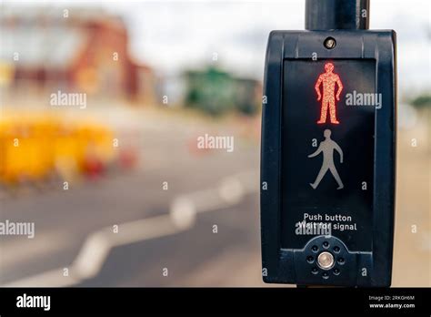 A Closeup Of A Pedestrian Crossing Push Button Traffic Signal Control