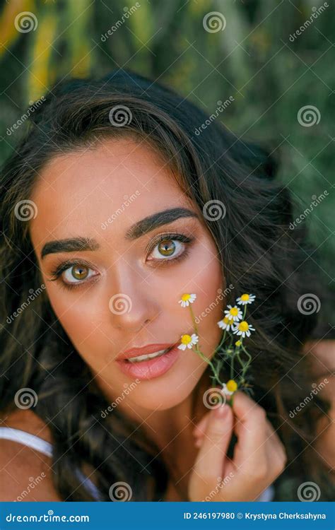 Portrait Of A Beautiful Dark Haired Curly Young Woman 30 Years Old In A White Sundress In A