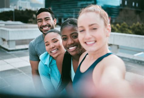 Portrait Of A Diverse Group Of Happy Sporty People Taking Selfies While Exercising Together