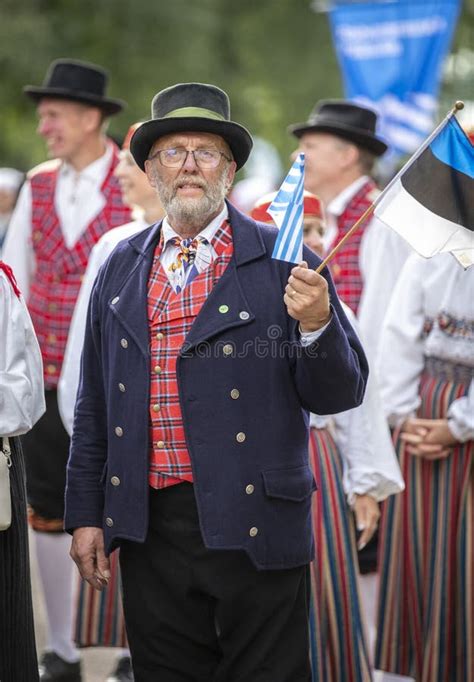 Estonian People In Traditional Clothing Walking The Streets Of Tallinn