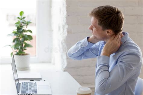 Millennial Tired Man Having A Neck Pain Stock Photo Image Of Hurt