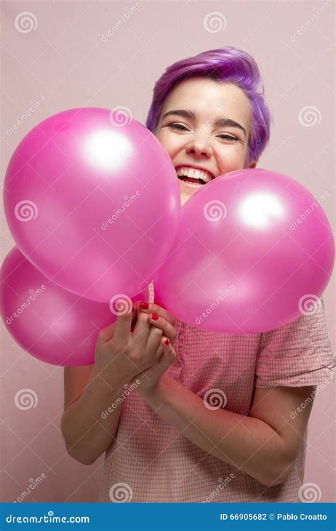 Violet Short Haired Woman In Pink Pastel Laughing Behind Balloon Stock