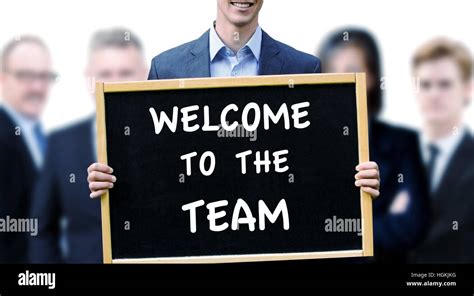 Young Businessman Holding A Sign With The Words Welcome To The Team