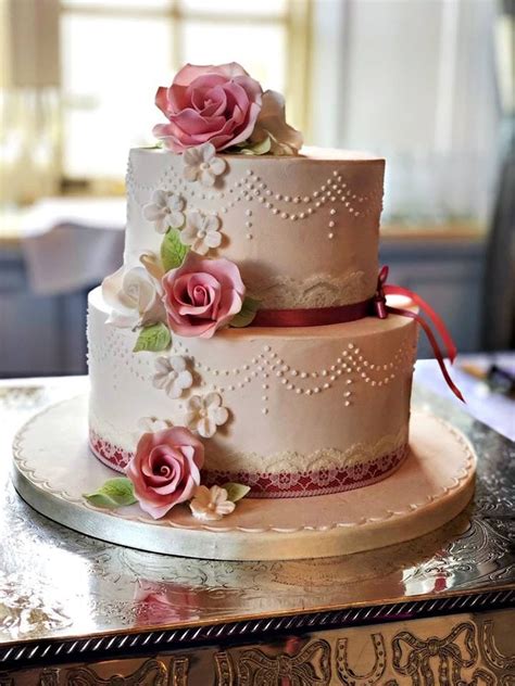 Two tiered wedding cakes can be decorated simply but still look nice and elegant. Carlie, pretty 2 tier cake with lace detail, piping and ...