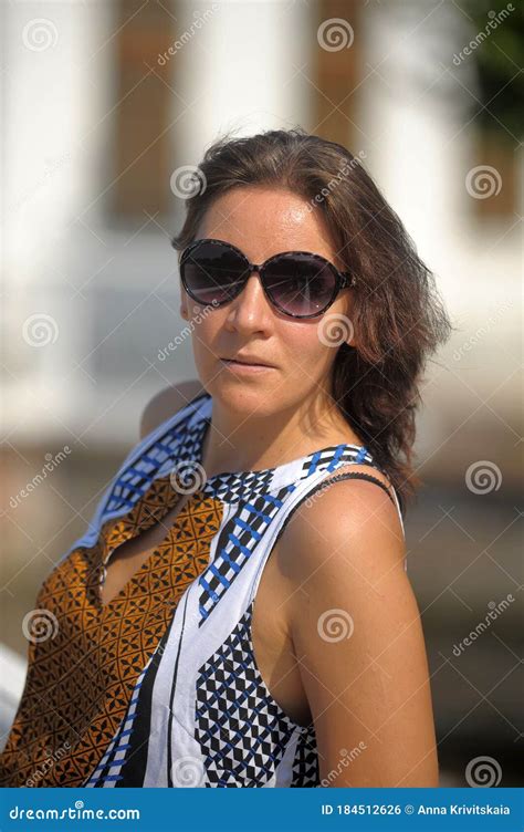 Brunette Woman In Summer Wearing Sunglasses Portrait Stock Photo
