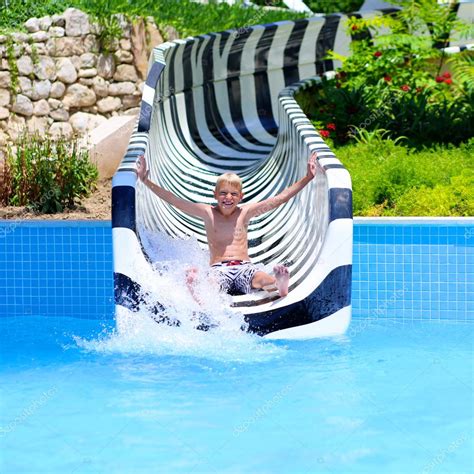 Boy Having Fun On Water Slide — Stock Photo © Cromary 113873378