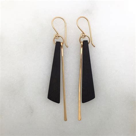 These Elegantly Asymmetrical Earrings Feature A Sliver Of Ebony