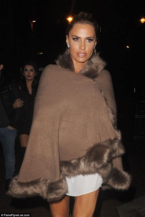 Katie Price Wears A Skimpy White Top With Boots And Furry Poncho Daily Mail Online