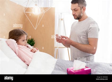 Caring Daddy Taking Care Of His Sick Daughter Stock Photo Alamy
