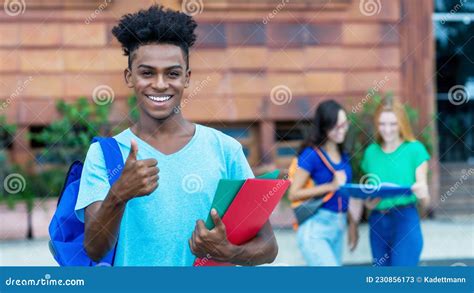 Successful African American Male Student Showing Thumb Up With Group Of