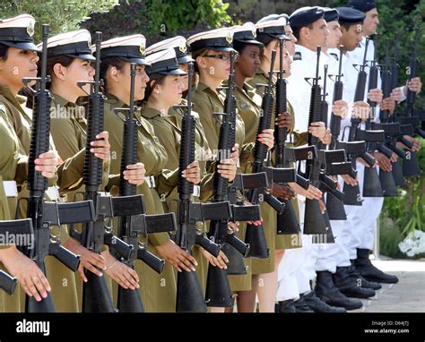 Female And Male Soldiers Of The Israeli Army Wait For The Arrival Of