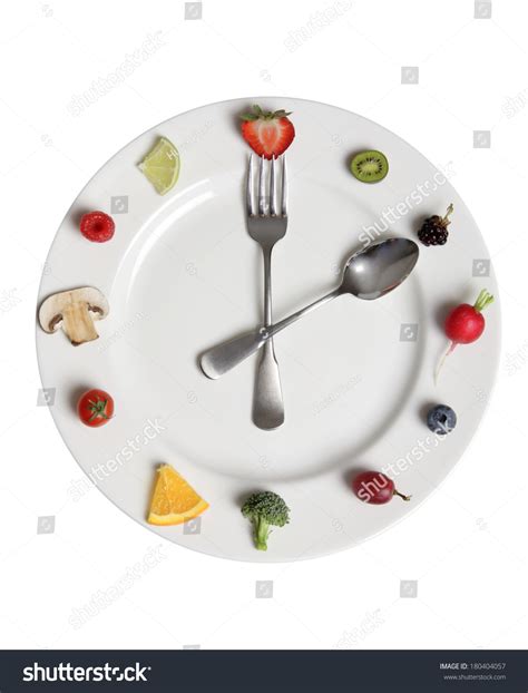 Food Clock Made Of Fruits And Vegetables On White Plate Stock Photo