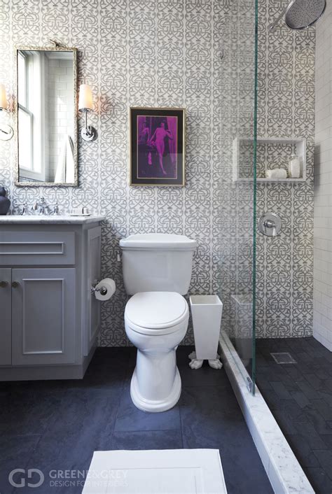 The slate tile, the tankless toilet, the modern vases in the window. Beautifully wallpapered bathroom, with a pop of color ...