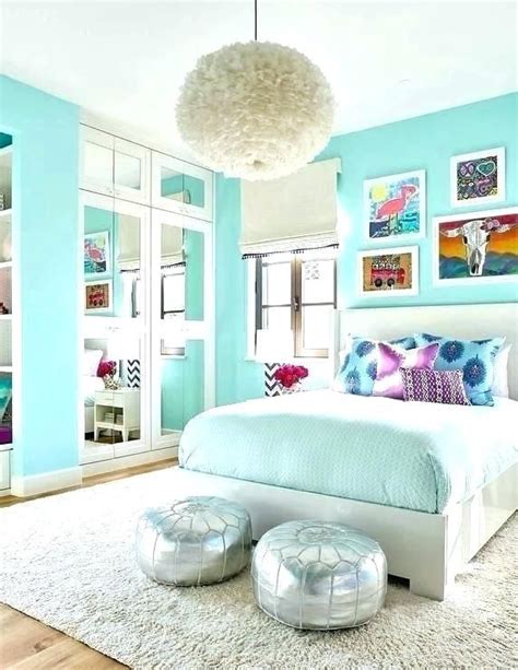 A Bedroom With Blue Walls White Furniture And Pictures On The Wall