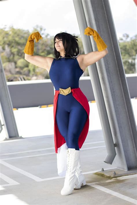 A Woman Dressed In A Blue And Red Costume With Yellow Gloves Is Posing For The Camera