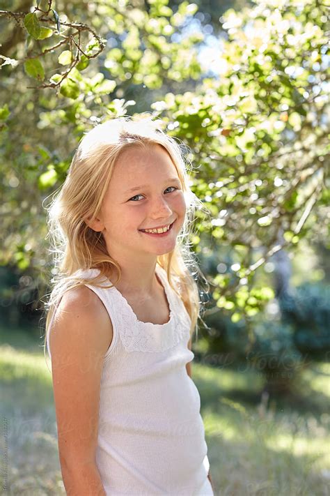 Portrait Of Little Girl With Blonde Hair Outdoors By Stocksy