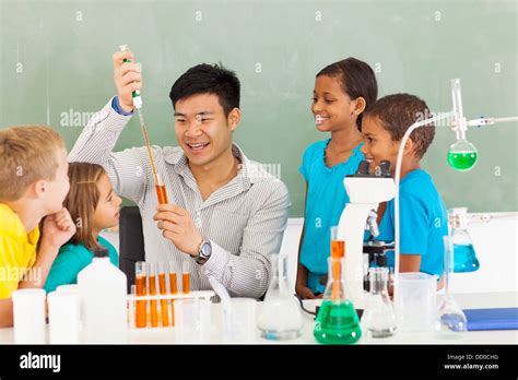 Primary School Science Teacher Demonstrating Science Experiment Stock