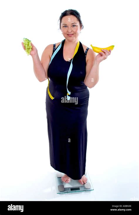 Self Confident Chubby Woman On Scale With Tape Measure And Fruits