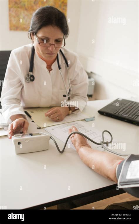 Doctor Checks Patients Blood Pressure Stock Photo Alamy