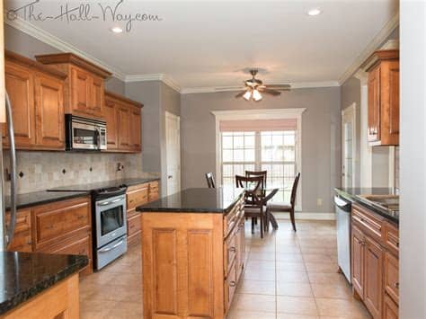 Use it to hold all your dining call for the convenience in your dining room through bago range. Honey Oak Cabinets With Black Hardware Granite Grey Wood ...