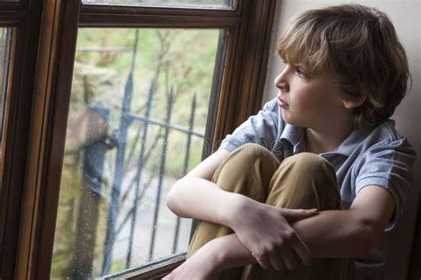 Sad Young Boy Child Looking Out Window Stock Photo Image Of Sitting