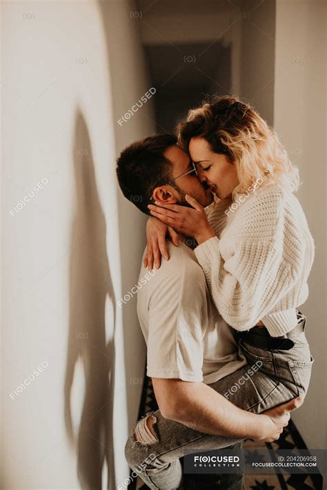 Passionate Man And Woman Embracing And Kissing At Wall At Home — Happy