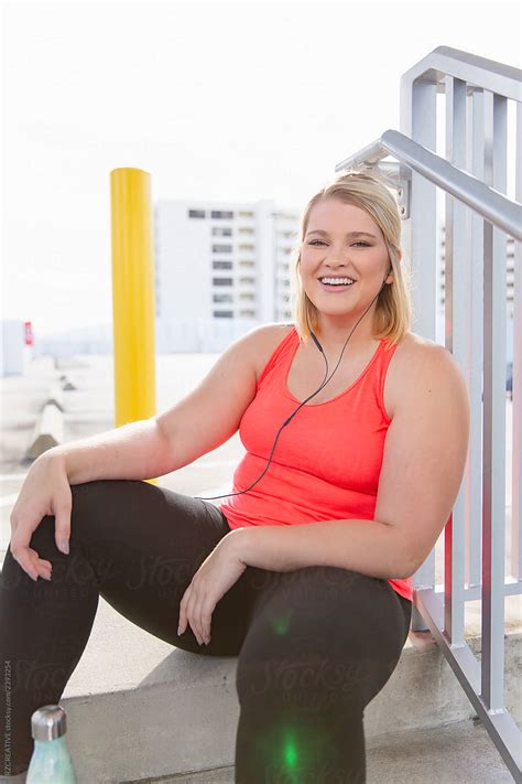 curvy woman smiling after workout by stocksy contributor rzcreative stocksy