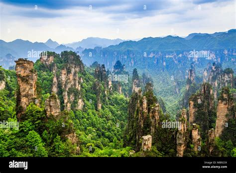 Quartzite Sandstone Pillars And Peaks With Green Trees And Mountains