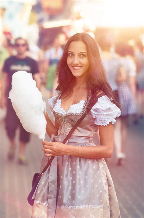 German Girl Wearing A Dirndl And Eating Candyfloss Stock Image Image
