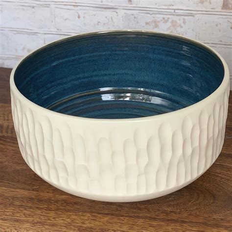 This Wheel Thrown Ceramic Bowl Is Hand Carved On The Outside In A Mid