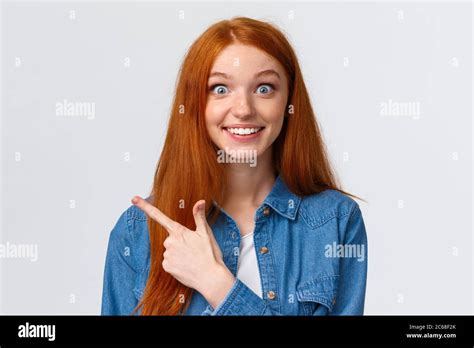 Excited And Impressed Curious Thrilled Smiling Redhead Girl With Long