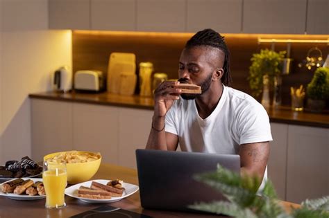 Free Photo African American Man Eating Late At Night