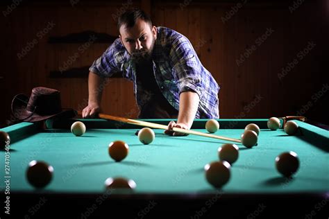 A Man With A Beard Plays A Big Billiard Party In A 12 Foot Pool Billiards In The Club Game For