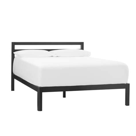 A Bed With White Sheets And Black Frame