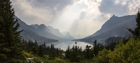 Sunlight From Above The Clouds Over The Lake At Glacier National Park