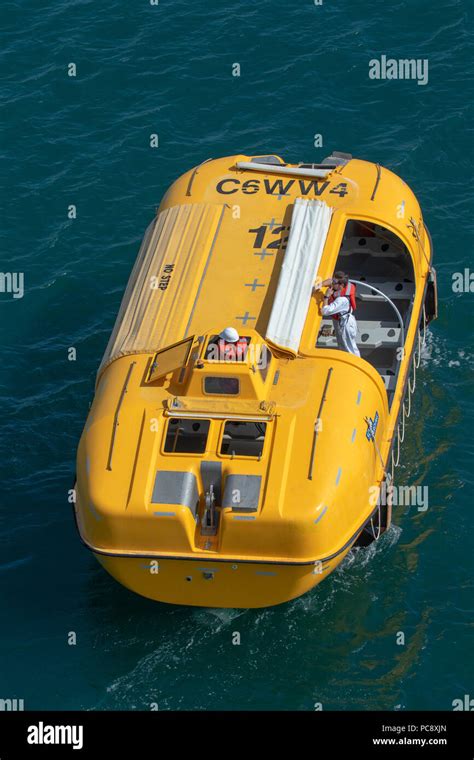 A Yellow Lifeboat From The Royal Caribbean Independence Of The Seas Cruise Ship Being Driven