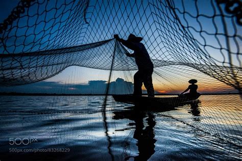 Fisherman Using Fishing Net To Catch Fish Fishing Net Photography