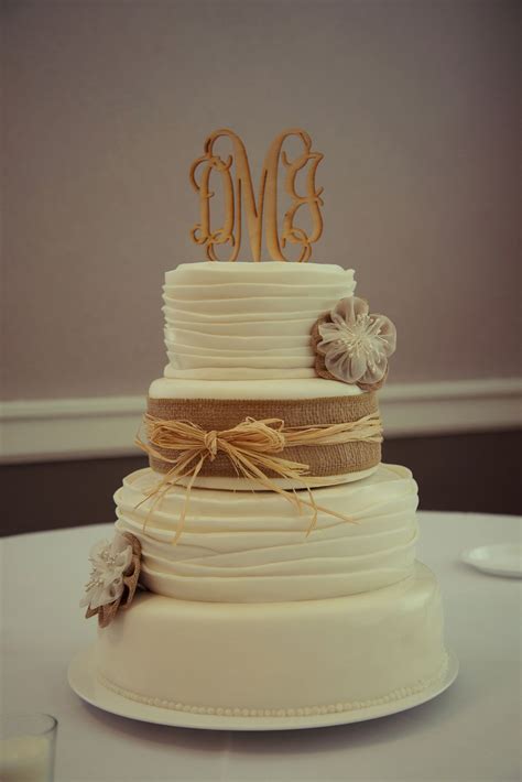 Rustic Wedding Cake With Burlap And Straw Ribbon And Monogram Cake Topper