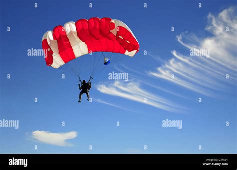 Red Parachute Landing On Blue Sky Stock Photo Alamy