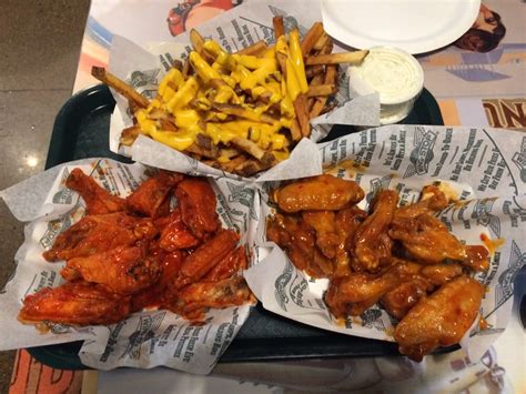 Place the cooked potatoes onto a plate lined with paper towels. Cheese fries, original hot wings, and mango habanero wings ...