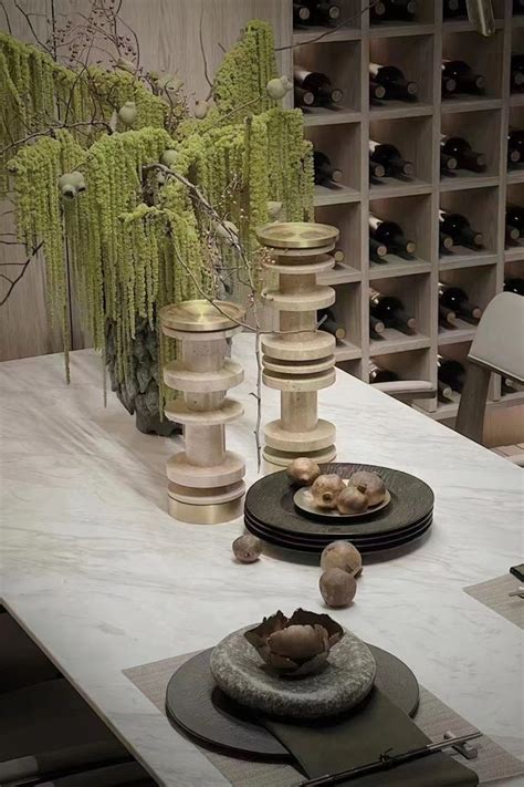 A Table Topped With Plates And Vases Filled With Flowers Next To