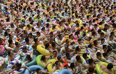 Visitors Crowd An Artificial Wave Swimming Pool At A Tourist Resort To