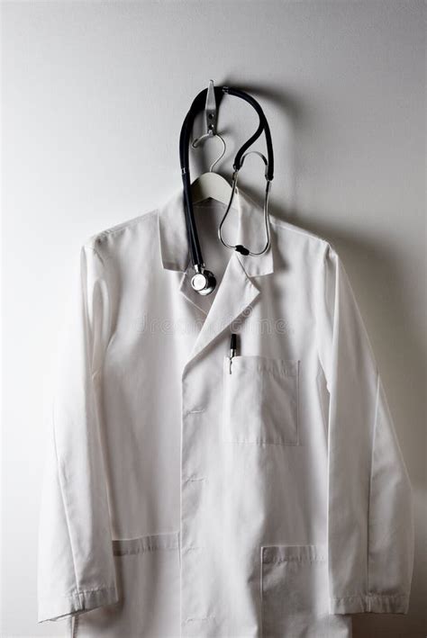 Doctors White Lab Coat On A Hanger And Hook With Stethoscope Stock