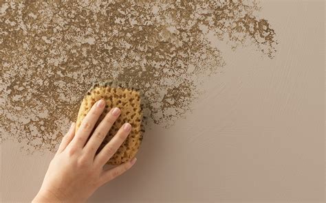 A Person Sponging Texture Onto A Beige Wall Wall Texture Design