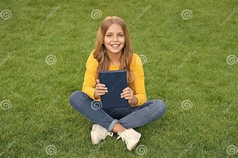 Teen Girl Inspired With New Book Relax On Green Grass Spring Leisure