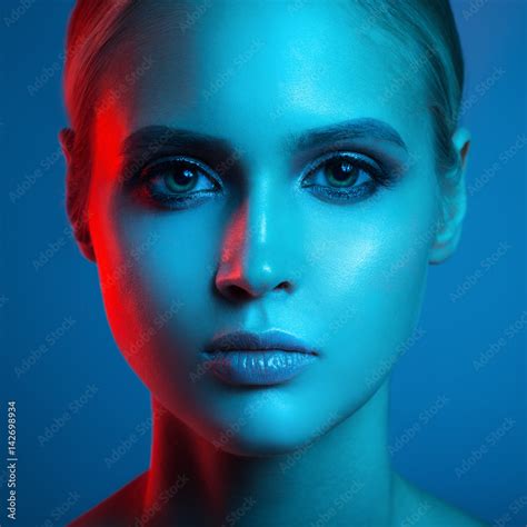 Fashion Art Portrait Of Beautiful Woman Face Red And Blue Light Color