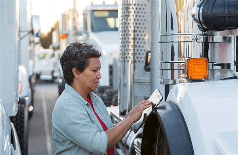 Female Truck Driver And Fleet Of Trucks By Stocksy Contributor