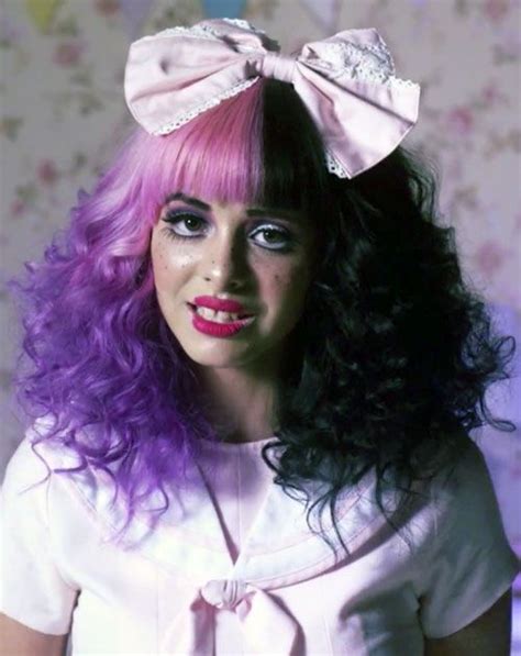 A Woman With Purple Hair Wearing A Pink Bow